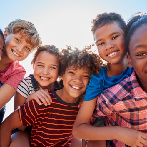 Six,Pre-teen,Friends,Piggybacking,In,A,Park,,Close,Up,Portrait